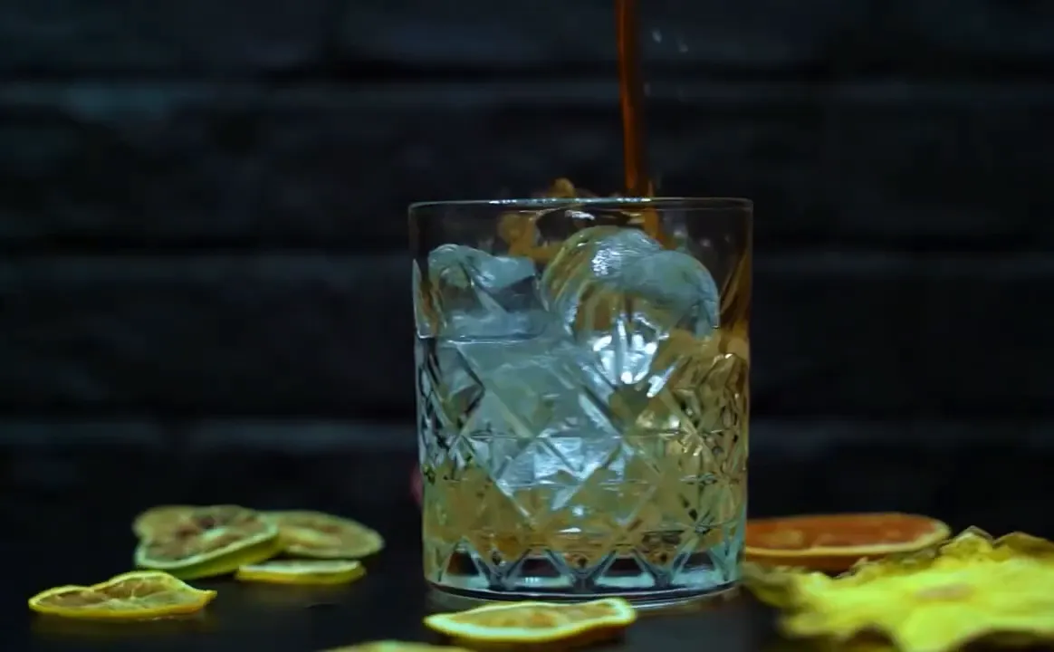 Glass of alcoholic drink on table